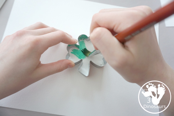 Clover Watercolor Painting for kids - You use watercolor paints, watercolor paper, and clover cookie cutters to make a fun Saint Patrick's Day watercolor painting - 3Dinosaurs.com