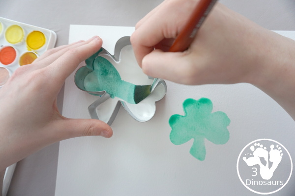 Clover Watercolor Painting for kids - You use watercolor paints, watercolor paper, and clover cookie cutters to make a fun Saint Patrick's Day watercolor painting - 3Dinosaurs.com