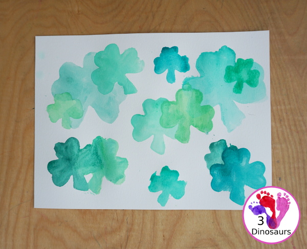Clover Watercolor Painting for kids - You use watercolor paints, watercolor paper, and clover cookie cutters to make a fun Saint Patrick's Day watercolor painting - 3Dinosaurs.com