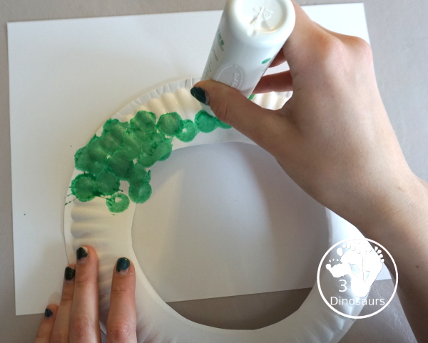 Glitter Easter Egg Wreath Craft - a fun Easter Egg wreath made with a paper plate and ovals for the eggs - 3Dinosaurs.com