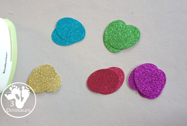 Glitter Easter Egg Wreath Craft - a fun Easter Egg wreath made with a paper plate and ovals for the eggs - 3Dinosaurs.com