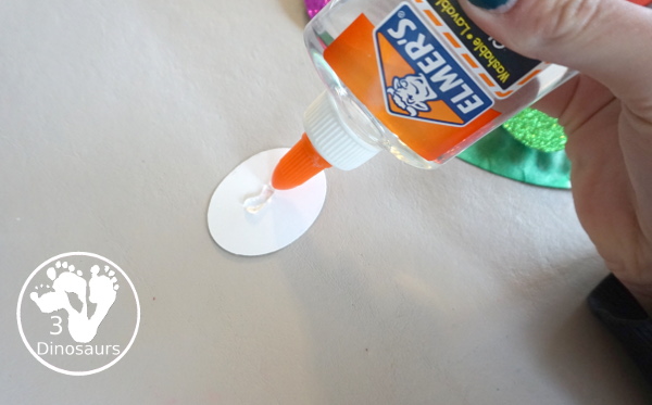 Glitter Easter Egg Wreath Craft - a fun Easter Egg wreath made with a paper plate and ovals for the eggs - 3Dinosaurs.com