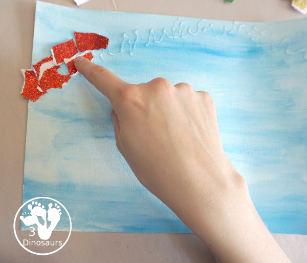 Torn Paper Glitter Rainbow with watercolor Sky Craft - a simple rainbow you can make with torn glitter paper and painting a watercolor background. A simple rainbow for kids prek to first grade - 3Dinosaurs.com