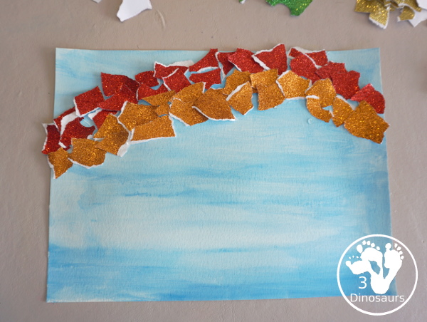 Torn Paper Glitter Rainbow with watercolor Sky Craft - a simple rainbow you can make with torn glitter paper and painting a watercolor background. A simple rainbow for kids prek to first grade - 3Dinosaurs.com