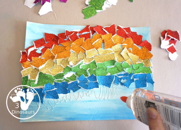 Torn Paper Glitter Rainbow with watercolor Sky Craft - a simple rainbow you can make with torn glitter paper and painting a watercolor background. A simple rainbow for kids prek to first grade - 3Dinosaurs.com