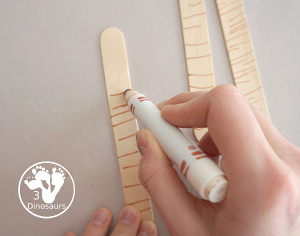 Washi Tape Truffula Tree Craft - a fun Lorax craft for kids to make with a little fun with fine motor truffula craft that kids can make. It is made with paper, washi tape and craft sticks. - 3Dinosaurs.com