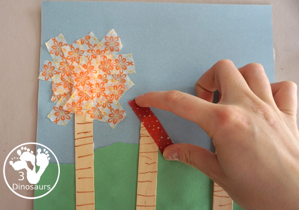 Washi Tape Truffula Tree Craft - a fun Lorax craft for kids to make with a little fun with fine motor truffula craft that kids can make. It is made with paper, washi tape and craft sticks. - 3Dinosaurs.com