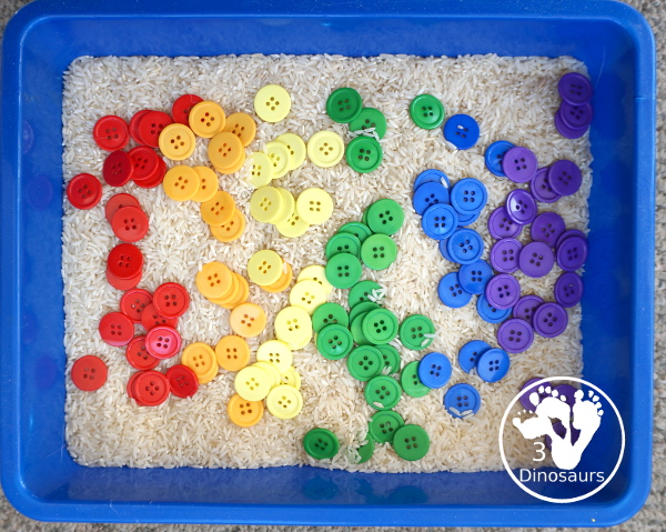 Rainbow Button Sensory Bin - a simple button sensory bin with a rice filler. You have buttons in the colors of the rainbow mixed in with the rice in the sensory bin. A simple and easy sensory bin to set up. - 3Dinosaurs.com