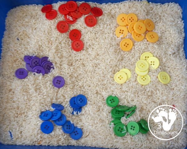Rainbow Button Sensory Bin - a simple button sensory bin with a rice filler. You have buttons in the colors of the rainbow mixed in with the rice in the sensory bin. A simple and easy sensory bin to set up. - 3Dinosaurs.com
