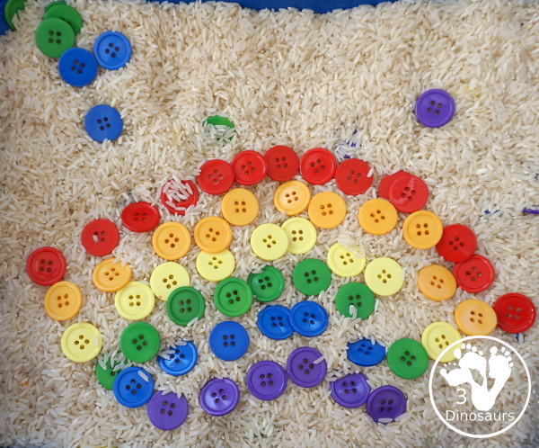 Rainbow Button Sensory Bin - a simple button sensory bin with a rice filler. You have buttons in the colors of the rainbow mixed in with the rice in the sensory bin. A simple and easy sensory bin to set up. - 3Dinosaurs.com