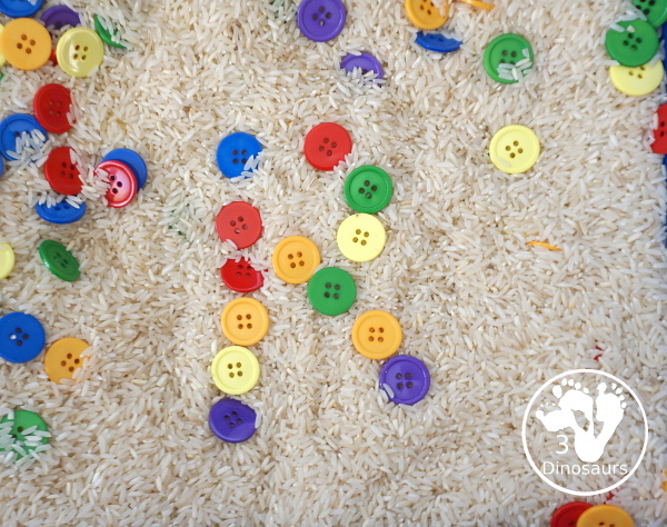 Rainbow Button Sensory Bin - a simple button sensory bin with a rice filler. You have buttons in the colors of the rainbow mixed in with the rice in the sensory bin. A simple and easy sensory bin to set up. - 3Dinosaurs.com