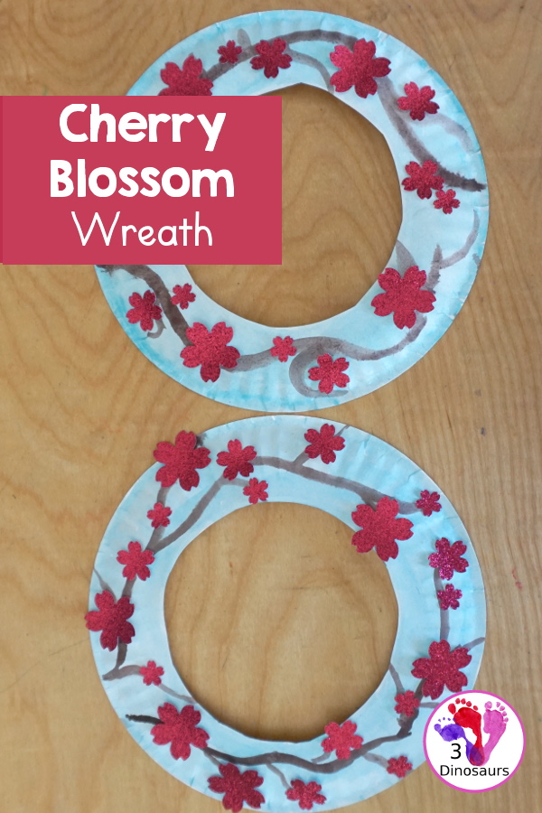 Cherry Blossom Wreath is a great spring wreath that kids can make with a paper plate for the base and watercolor and cherry blossom punches for the flowers. The Cherry Blossom Wreath is perfect for spring. - 3Dinosaurs.com