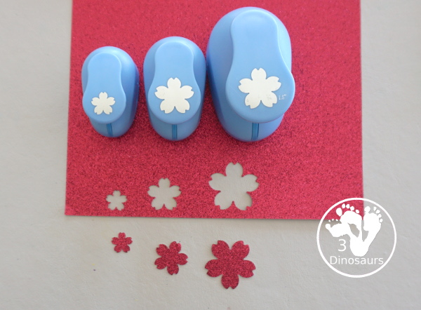 Cherry Blossom Wreath is a great spring wreath that kids can make with a paper plate for the base and watercolor and cherry blossom punches for the flowers. The Cherry Blossom Wreath is perfect for spring. - 3Dinosaurs.com