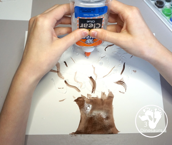 Spring Yarn Tree Craft For Kids - a fun craft made with watercolor for the tree trunk and yarn for the spring blossoms. Super easy to make and great for different ages. - 3Dinosaurs.com