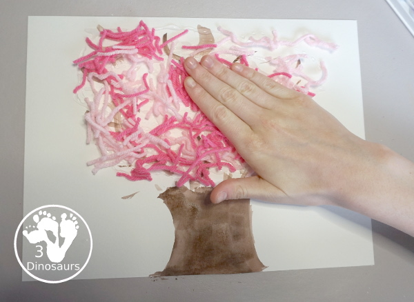 Spring Yarn Tree Craft For Kids - a fun craft made with watercolor for the tree trunk and yarn for the spring blossoms. Super easy to make and great for different ages. - 3Dinosaurs.com