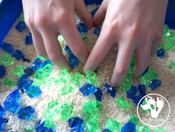 Blue and Green Sensory Bin For Earth Day - playing in the sensory bin with kids - 3Dinosaurs.com