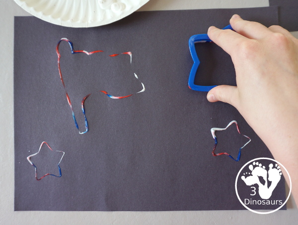 Red, White, and Blue Stamping - a simple painting with cookie cutters that you can do with kids using a flag shape and starts for the Fourth of July. - 3Dinosaurs.com