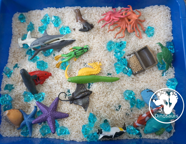 Ocean Rice and Rock Sensory Bin - a simple rice base sensory bin that has ocean animals and blue acrylic rocks in the bin. A simple sensory bin for any ocean theme - 3Dinosaurs.com