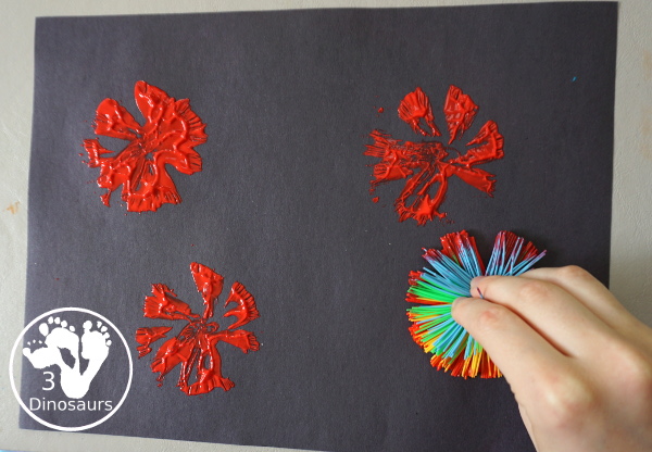 Red White and Blue Firework Painting - a fun painting to do for the Fourth of July with red, white and blue colors on black paper - 3Dinosaurs.com