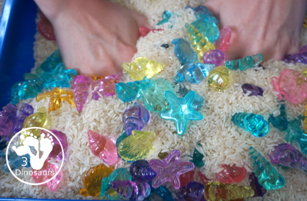 Shell and Rice Sensory Bin has a rice filler with acrylic sheets in different colors as the part in the sensory bin. This is a simple beach sensory bin idea for kids. - 3Dinosaurs.com
