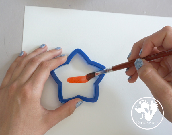 Stars & Flag Watercolor Painting with Cookie Cutters - a simple painting activity that you can do with kids with red and blue colors painting inside stars and flags.- 3Dinosaurs.com