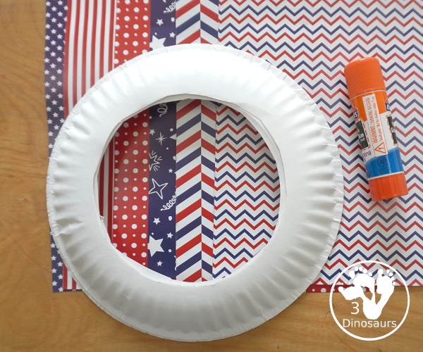 Red White and Blue Wreath Craft - a fun wreath craft made with scrapbook or any type Fourth of July paper with the red and blue themed paper around the paper plate. A simple craft you can do with preschool, prek and kindergarten age kids. - 3Dinosaurs.com