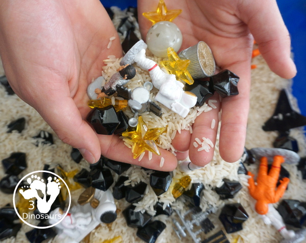Space Sensory Bin With Rice and Rocks - you have space figures, yellow stars, and rice for this simple sensory b8in. This is great for a space theme with kids. And they will enjoy exploring space themes in the sensory bin. A fun sensory bin for kids in preschool, prek and kindergarten. - 3Dinosaurs.com