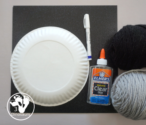 Yarn Moon Craft For Kids is simple to make with a paper plate, glue and yarn to make the moon. It is great for Moon Day or any moon theme you do with kids. - 3Dinosaurs.com