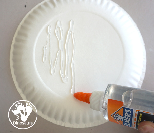 Yarn Moon Craft For Kids is simple to make with a paper plate, glue and yarn to make the moon. It is great for Moon Day or any moon theme you do with kids. - 3Dinosaurs.com