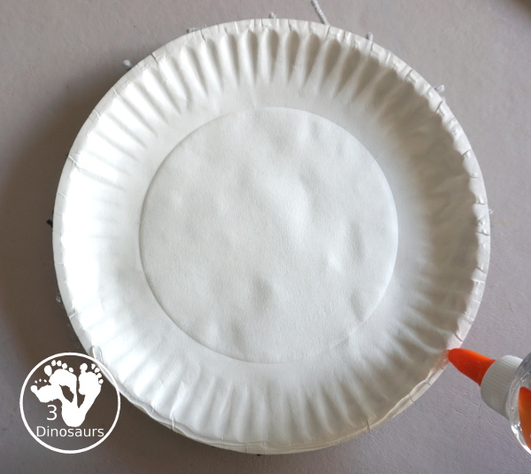 Yarn Moon Craft For Kids is simple to make with a paper plate, glue and yarn to make the moon. It is great for Moon Day or any moon theme you do with kids. - 3Dinosaurs.com