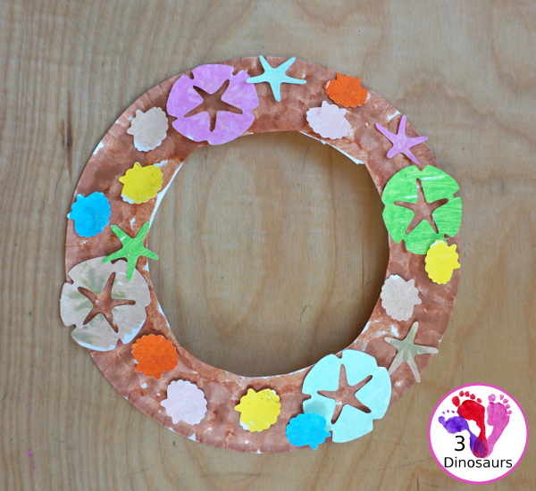 Beach Wreath Craft for Kids - a super easy to make beach craft with a wreath and shells kids can color and punch out to make the beach wreath. - 3Dinosaurs.com
