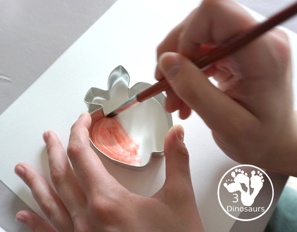 School Cookie Cutter Watercolor Painting - a super easy back to school watercolor painting with cookie cutters with school themes of pencils, scissors, crayons and apples - 3Dinosaurs.com