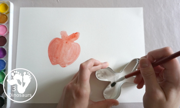 School Cookie Cutter Watercolor Painting - a super easy back to school watercolor painting with cookie cutters with school themes of pencils, scissors, crayons and apples - 3Dinosaurs.com