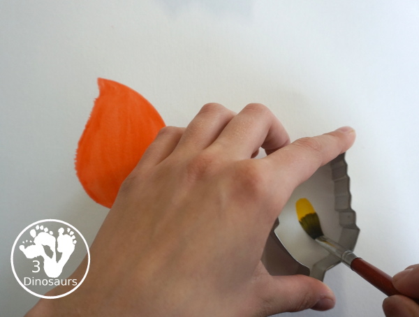 Leaves Cookie Cutter Painting - a fun fall painting wiht leaves. You can use a mix of red, yellow, orange and brown colors with this watercolor painting - 3Dinosaurs.com