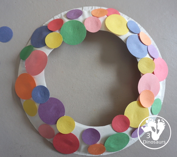 Circle Wreath Craft for Dot Day - a fun paper plate wreath with different colors of circles glued on the wreath - 3Dinosaurs.com
